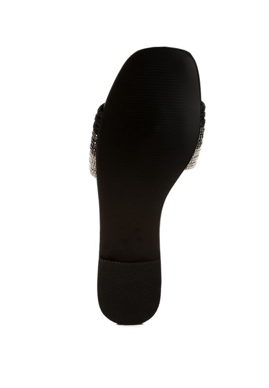 Back view of black slip-on flats with rhinestone trim and flat heel