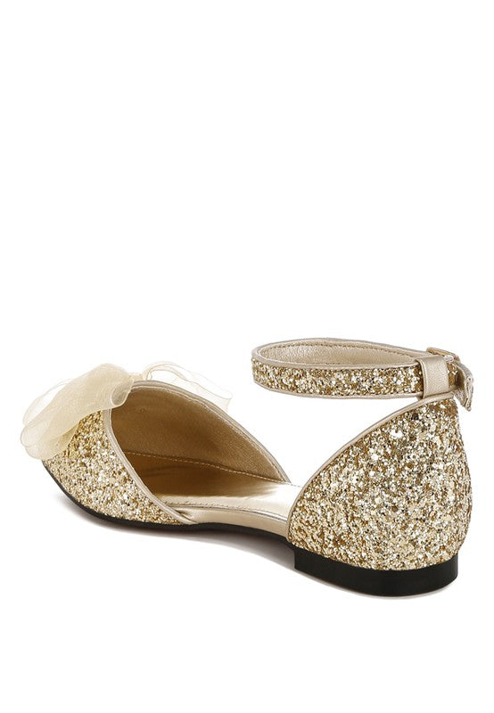 Side view: gold glitter flat sandal with sheer bow detail and pointed toe