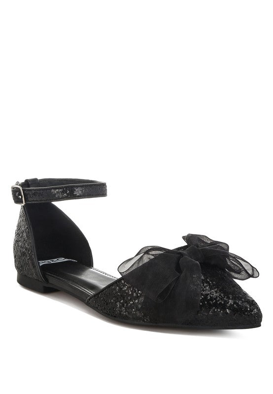 Black glitter pointed-toe flat sandal with sheer bow overlay and ankle strap