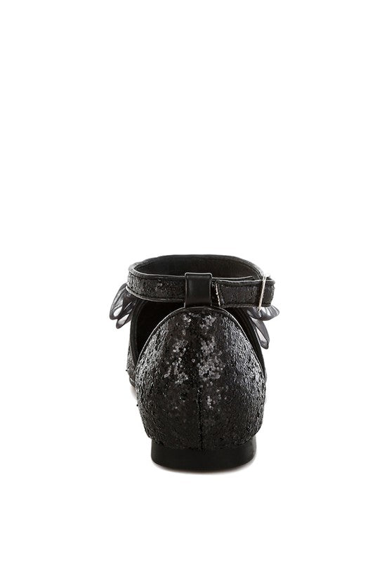 Black glitter flat sandal heel view, ankle strap with buckle and sheer bow detail