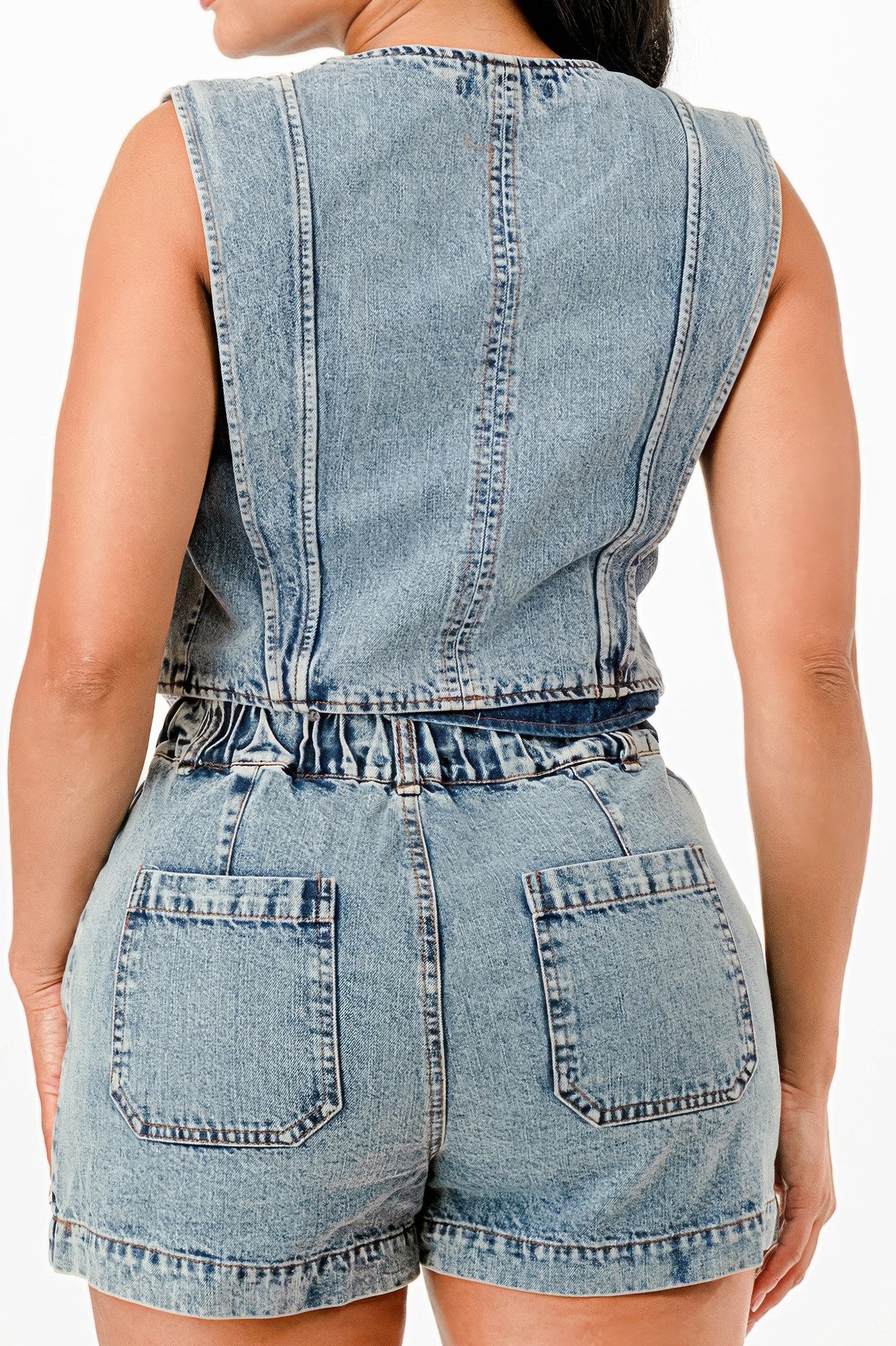 Back view denim vest with curved yoke seam and light-wash denim shorts