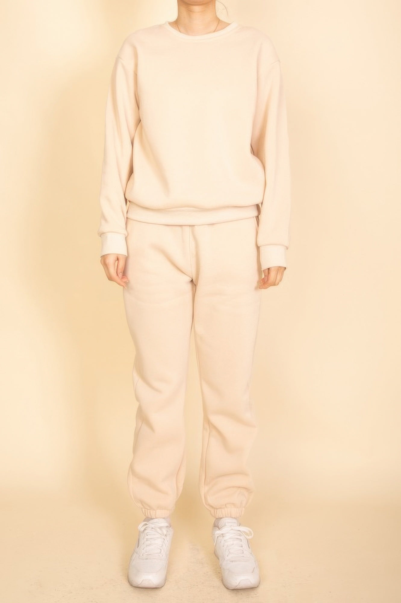 Stone/beige crewneck pullover with long sleeves and ribbed hem and cuffs