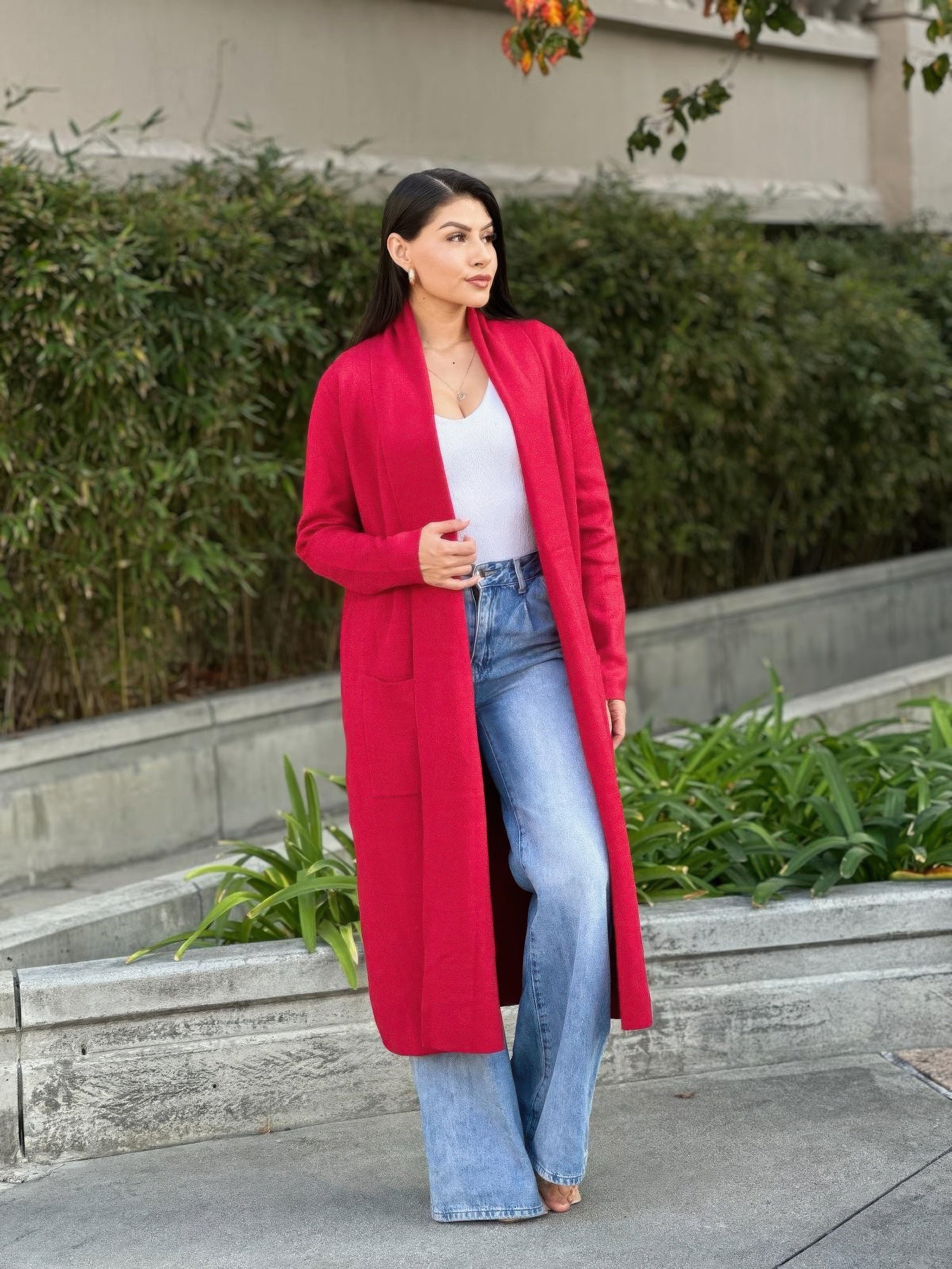 Red midi fine-knit cardigan showing side pockets and relaxed open-front fit