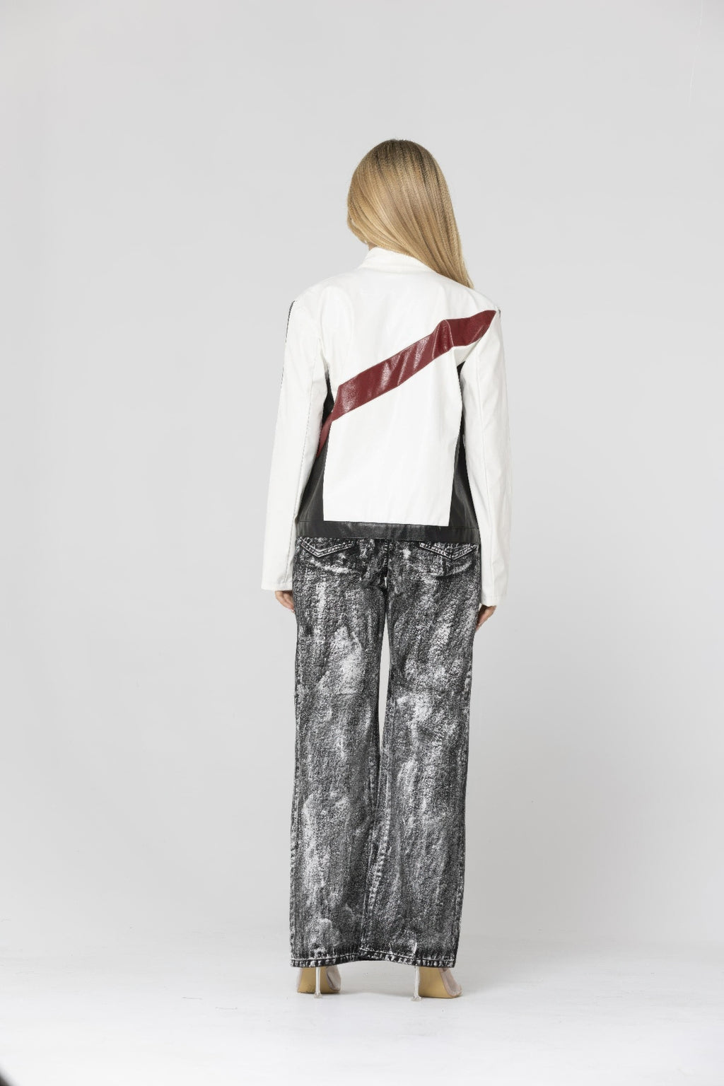Back view of color-block PU leather jacket with white sleeves and black-and-burgundy panel