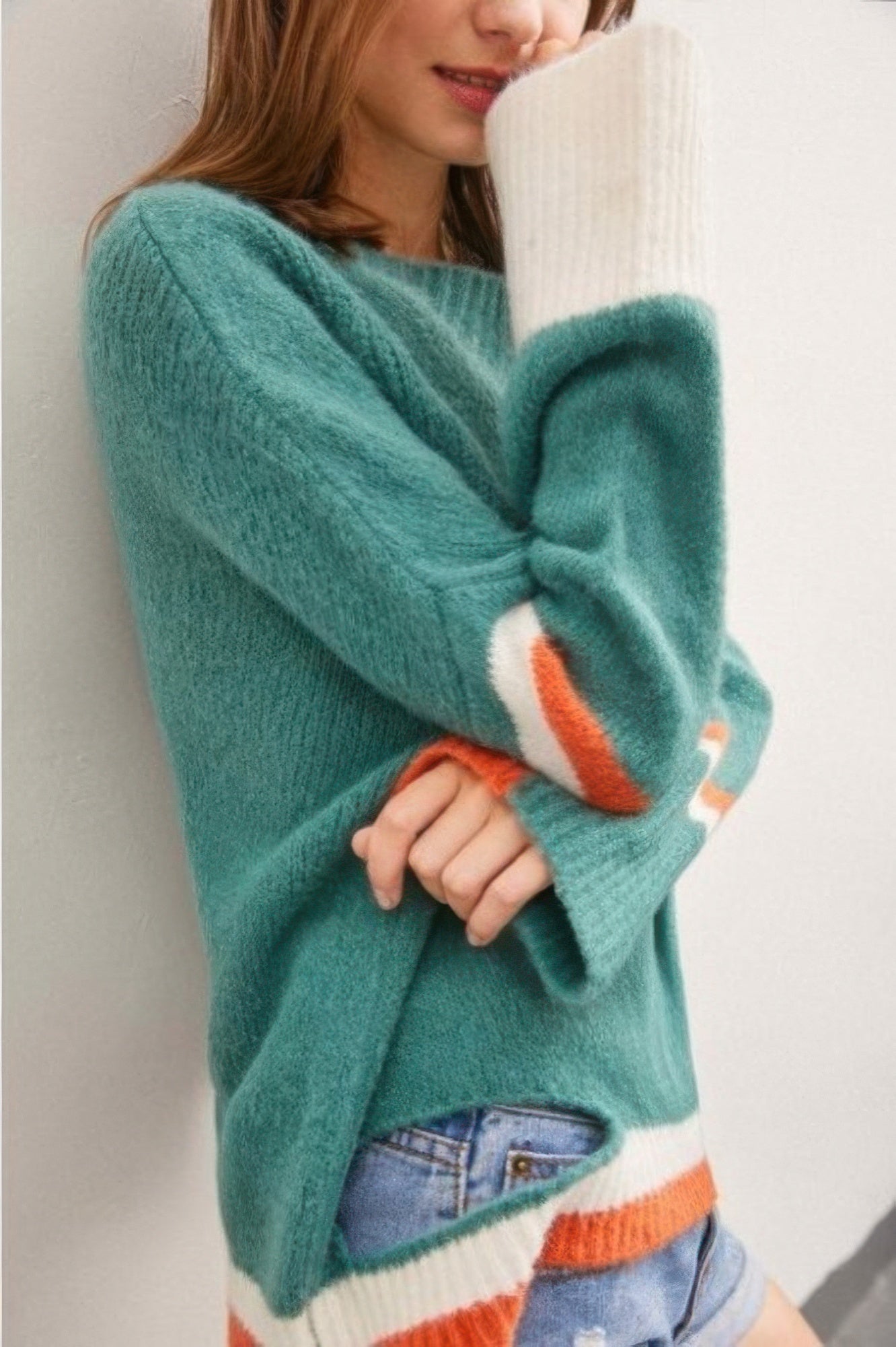 Teal crewneck sweater with white/orange cuff stripes and orange side cut-out