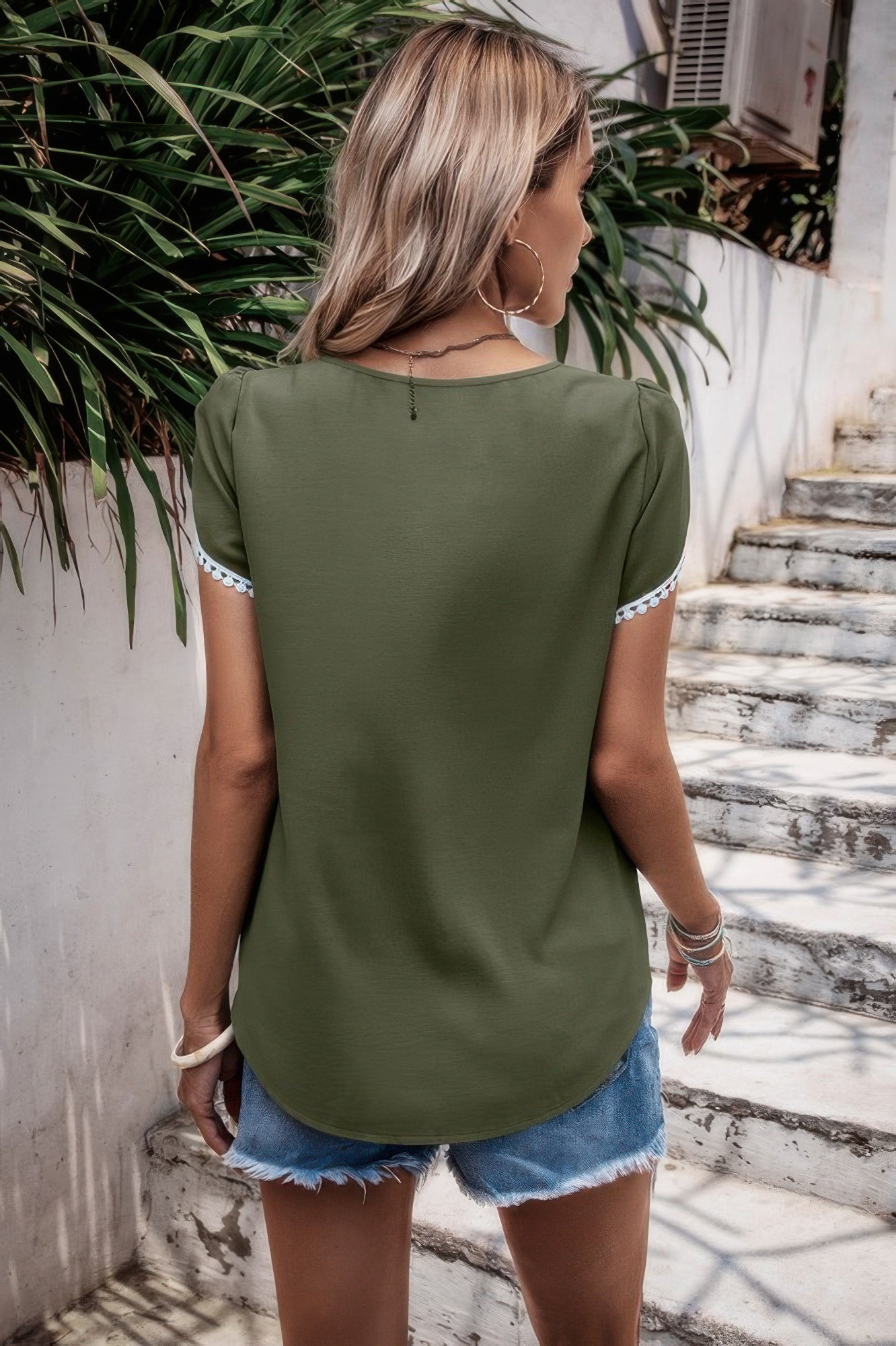 Olive round neck top with flutter sleeves and white trim, back view