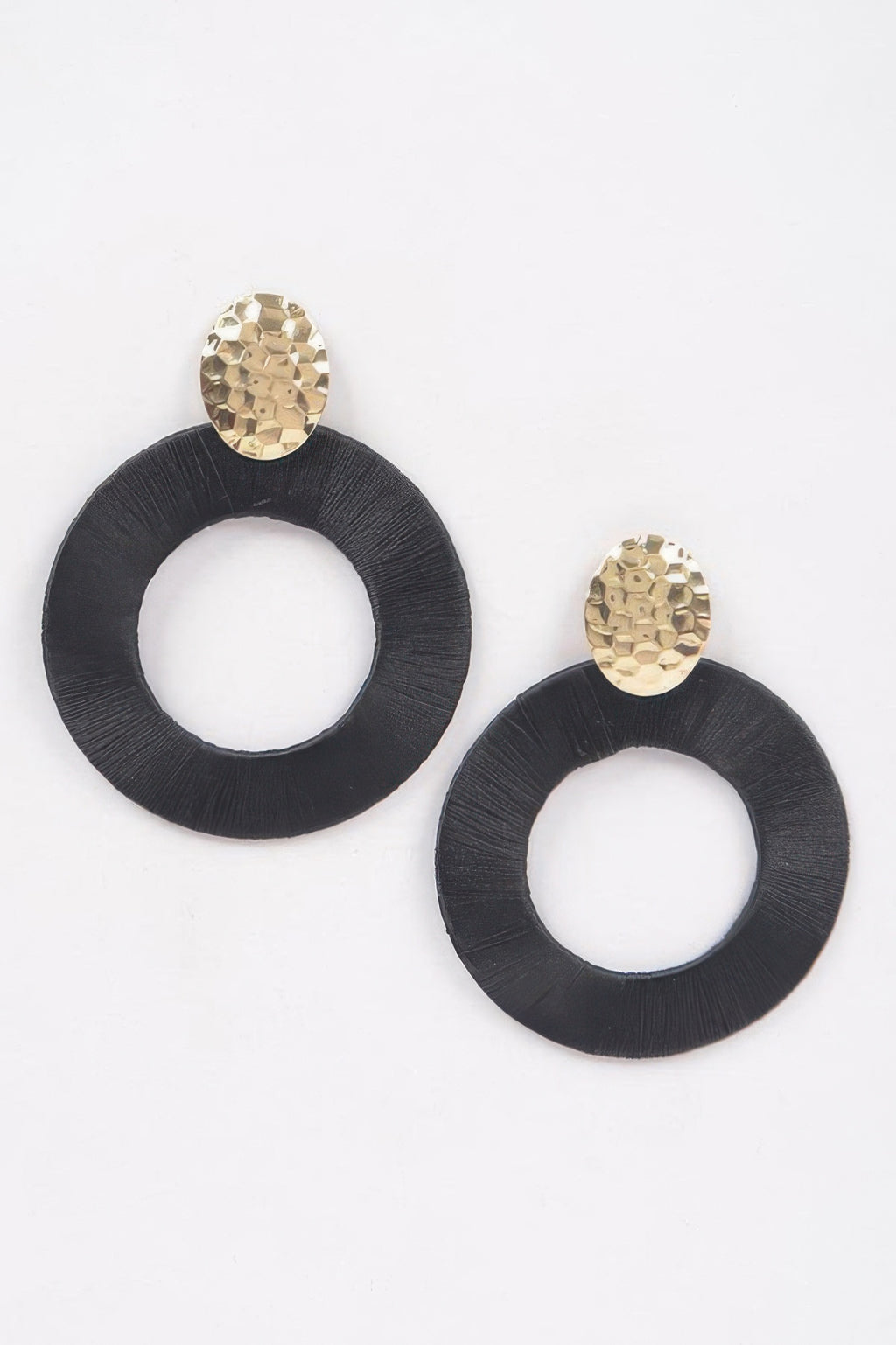 Colorful thread hoop earrings, black circular hoops with gold-toned stud tops.
