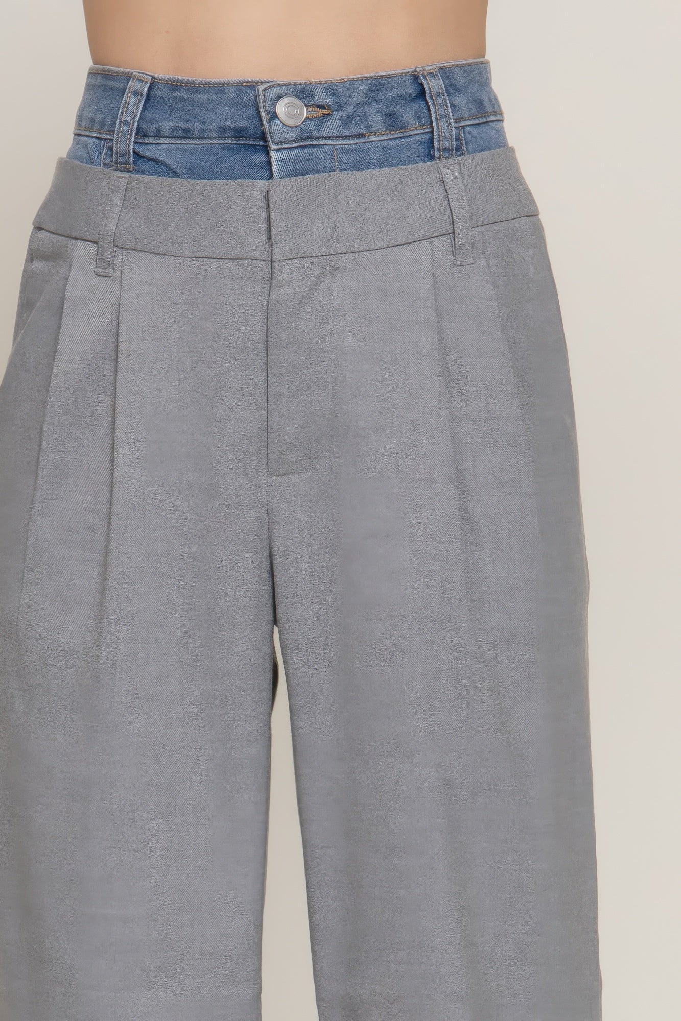 Heather grey denim pants, back view; contrast blue waistband and button closure