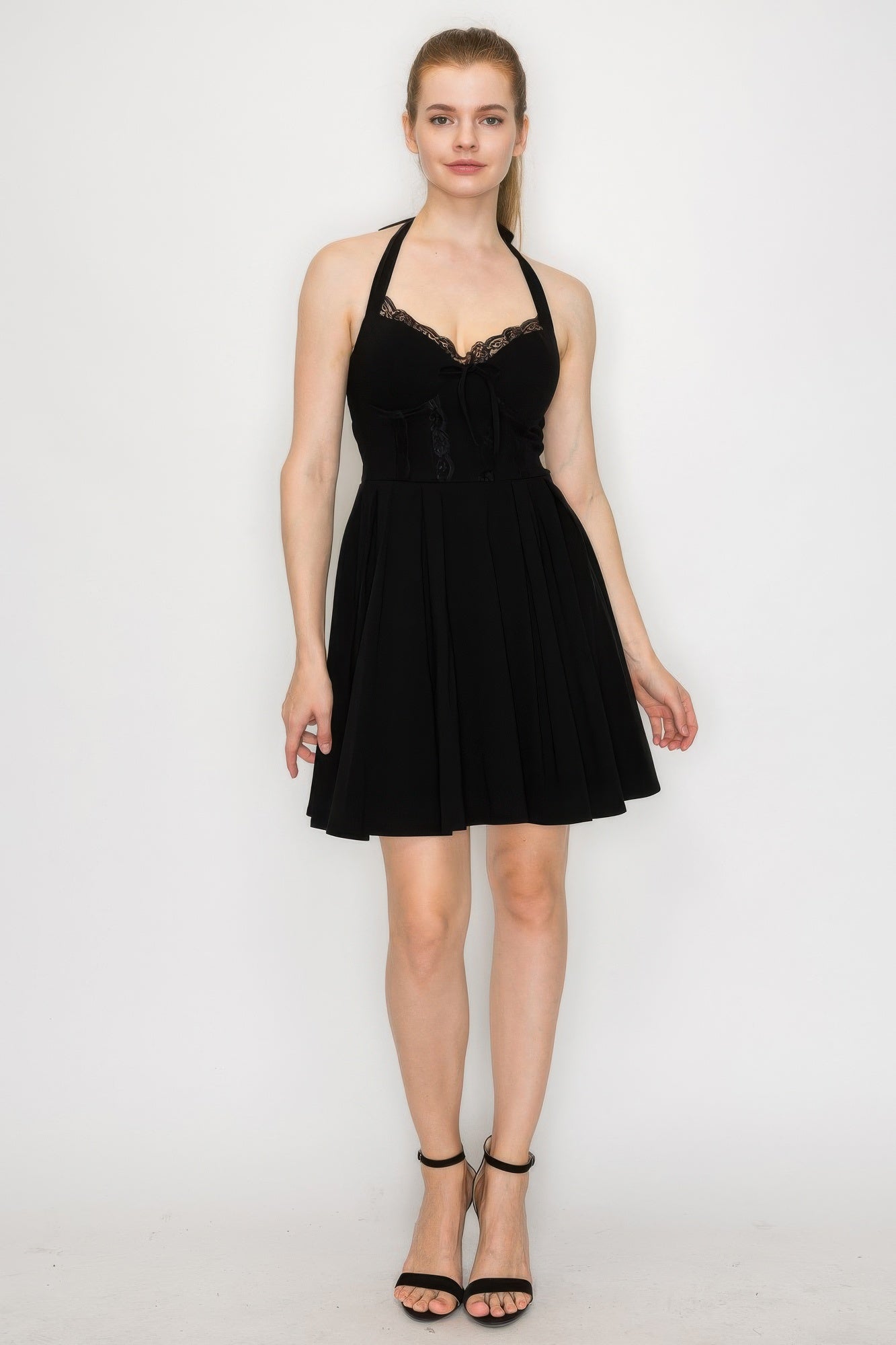 Black corset-style self-tie ribbon zip dress with lace-trim neckline and pleated skirt