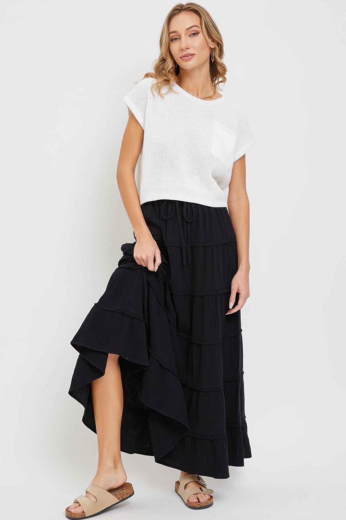Black tiered maxi skirt with tiered ruffle panels and drawstring elastic waist