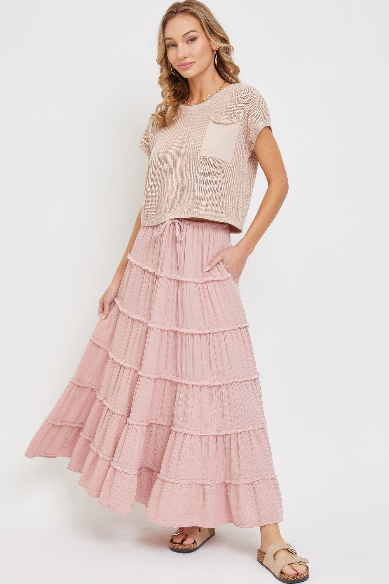 Blush pink tiered maxi skirt in cotton gauze, flared silhouette with ruffle layers