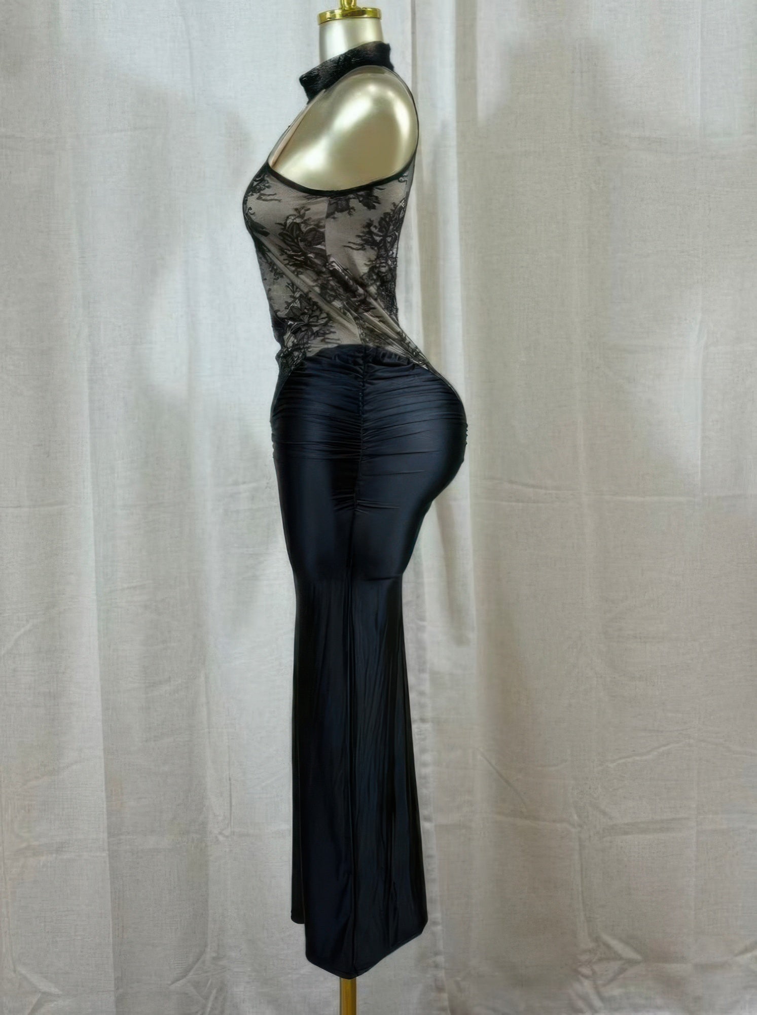 Side view black fitted lace hourglass dress with sheer floral bodice and draped ruched waist