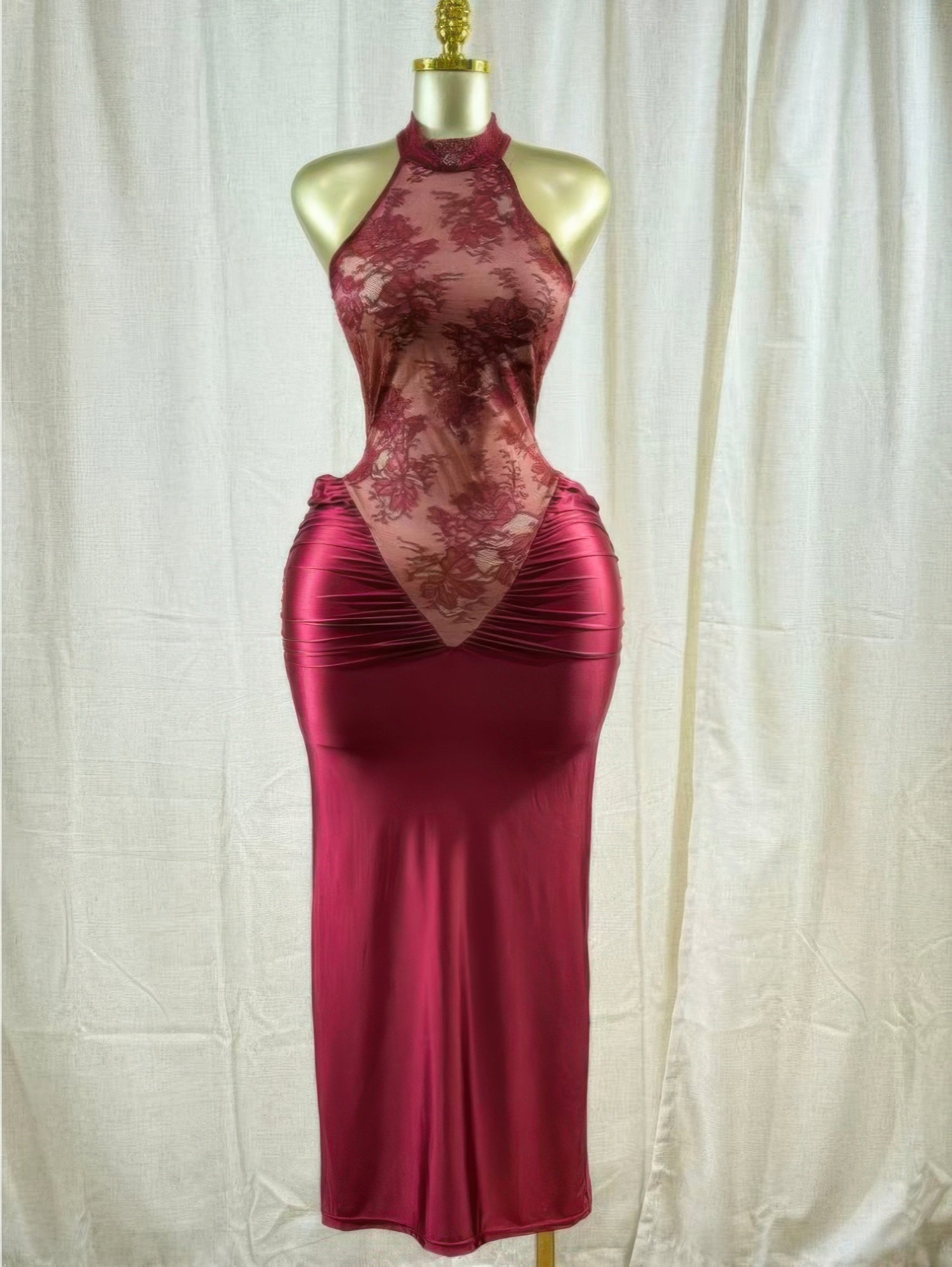 Crimson lace hourglass dress on mannequin: halter neckline, sheer floral panel, fitted maxi