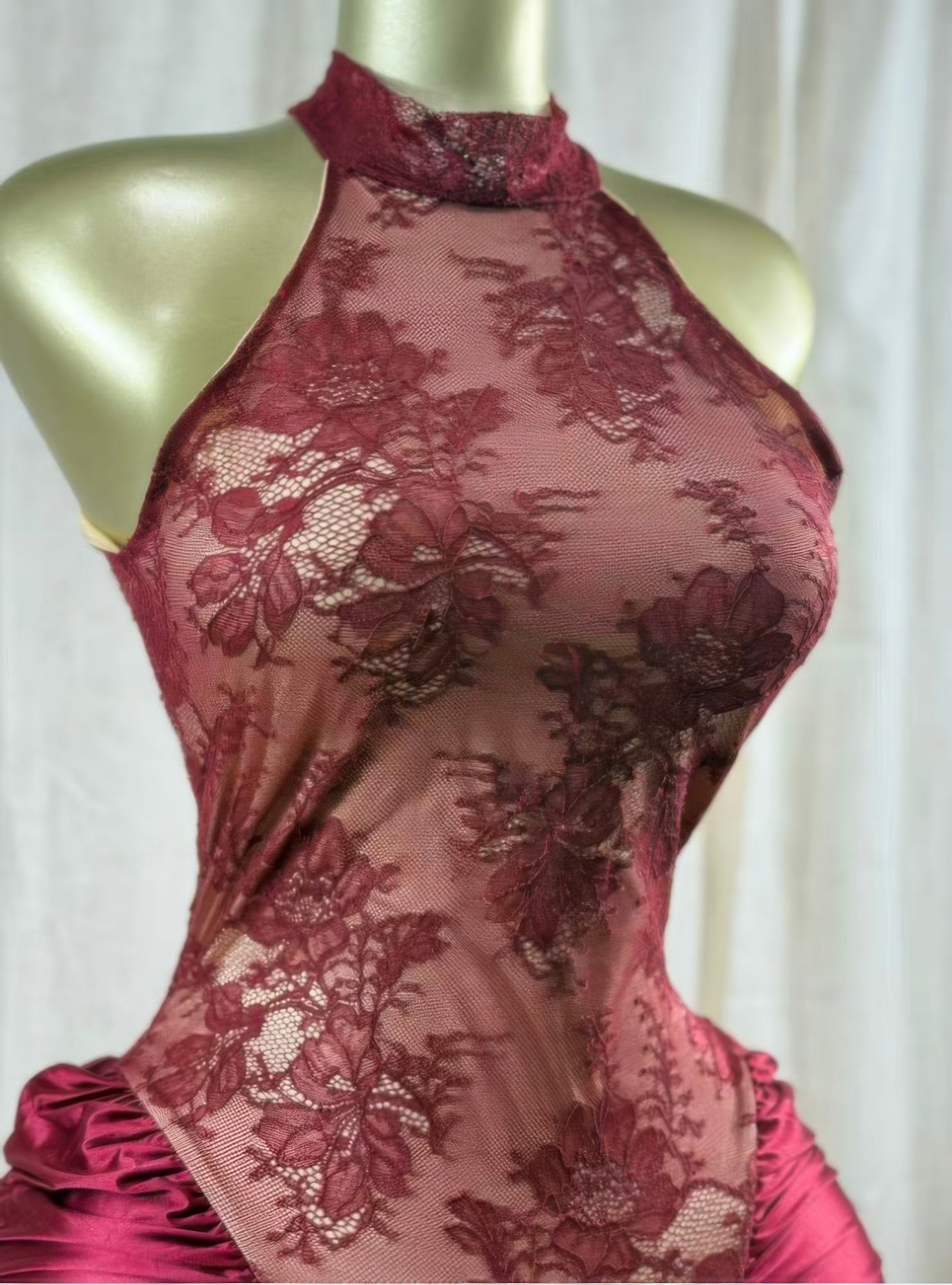 Red lace bodice with high neck and floral mesh pattern, ruched drape at waist