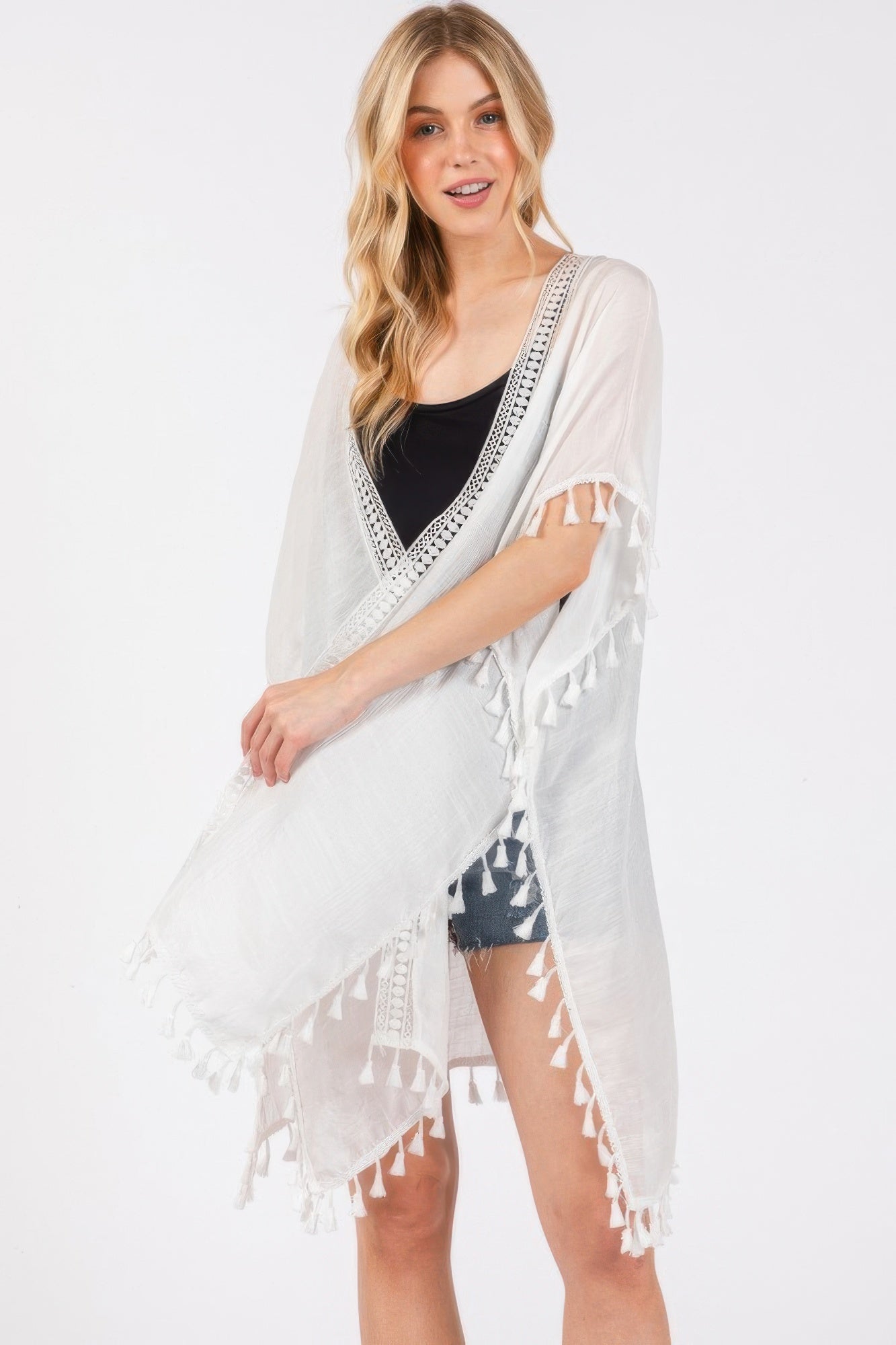 White crochet cover-up with V-neck border and tassel sleeves