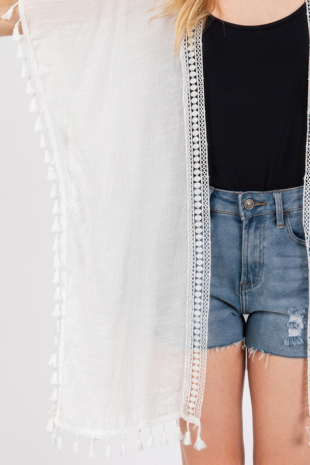 White cover-up with lace crochet trim border and tassel detail at edge