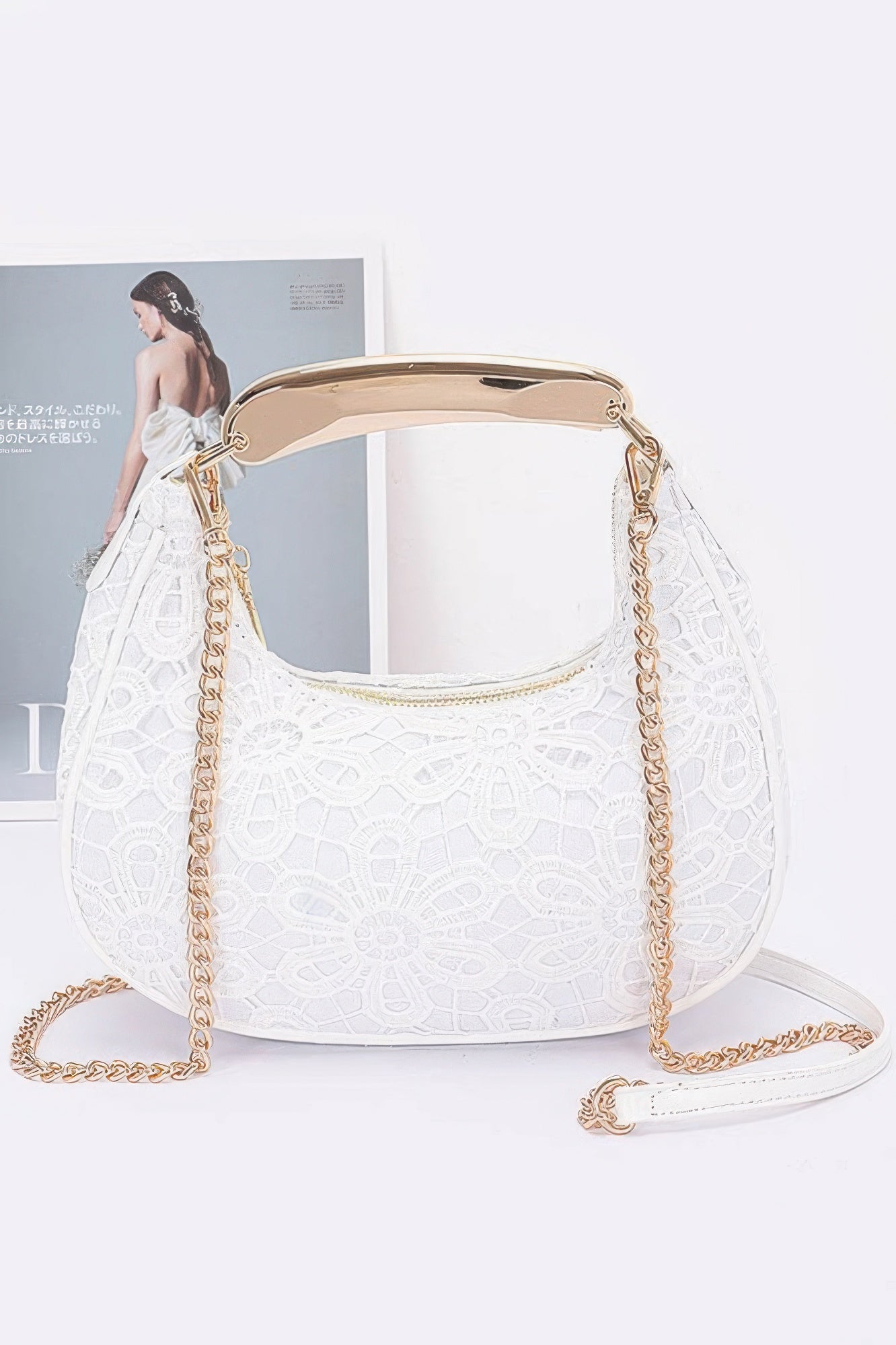 White crochet crossbody bag with gold-tone chain strap and curved handle top