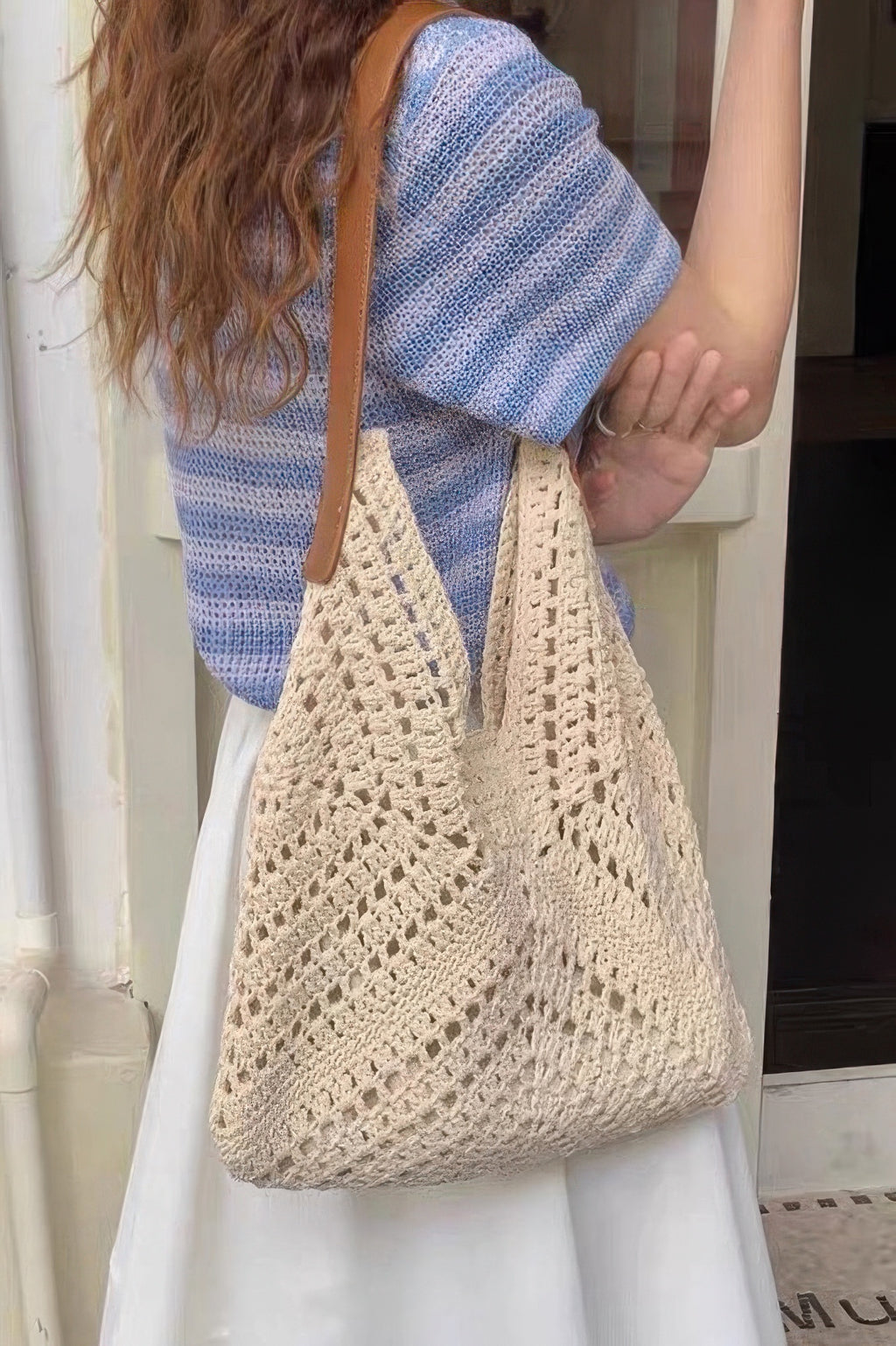 Crochet shoulder bag with pouch in khaki/cream, worn cross-body with openwork texture.