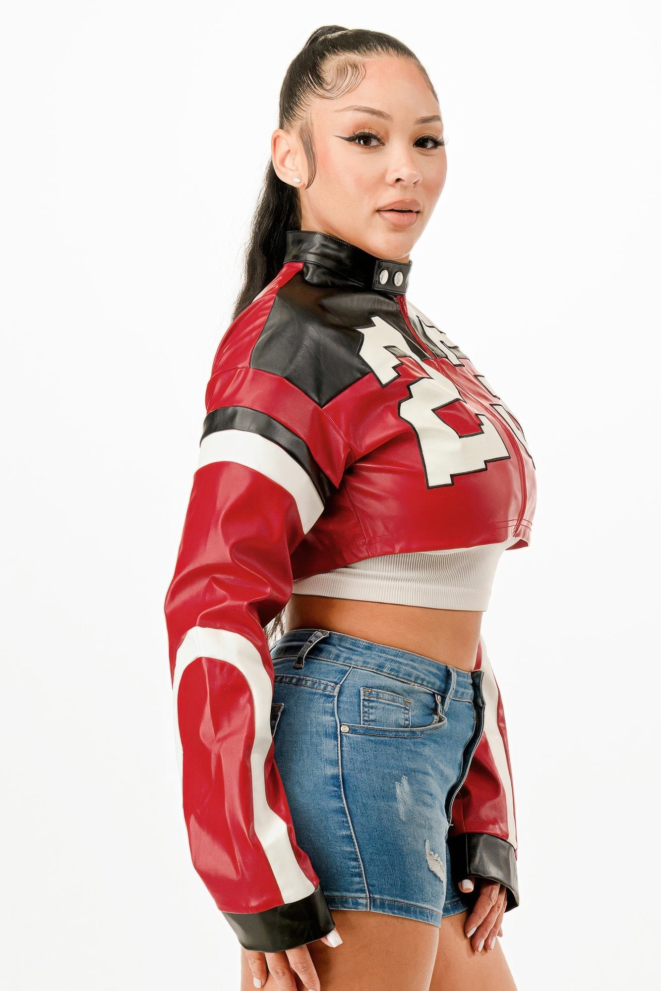 Cropped moto jacket side view: red-black panels with white number print, snap neck, zip front