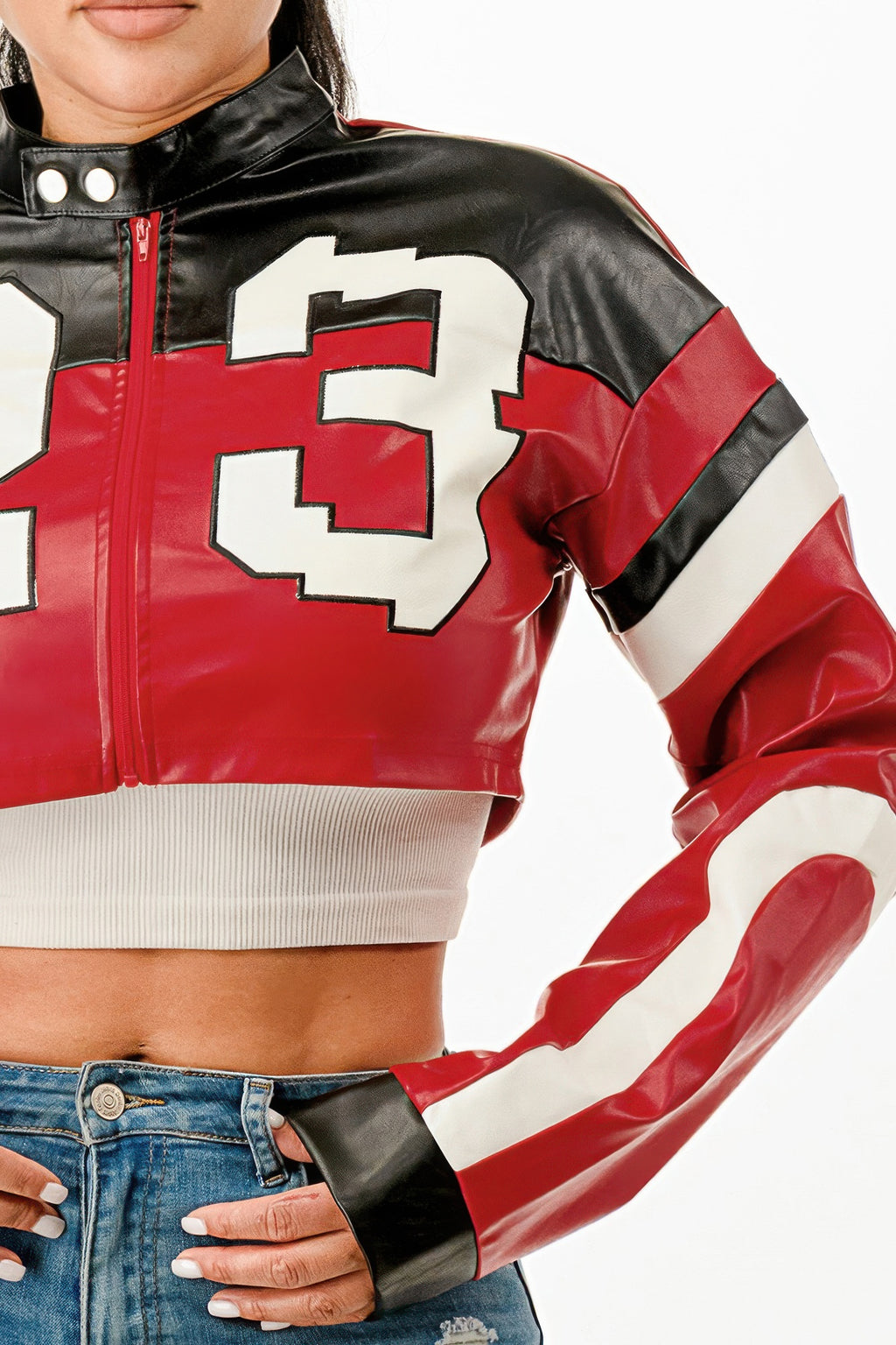Cropped moto jacket detail: glossy red front with white number graphic, zipper and black trims