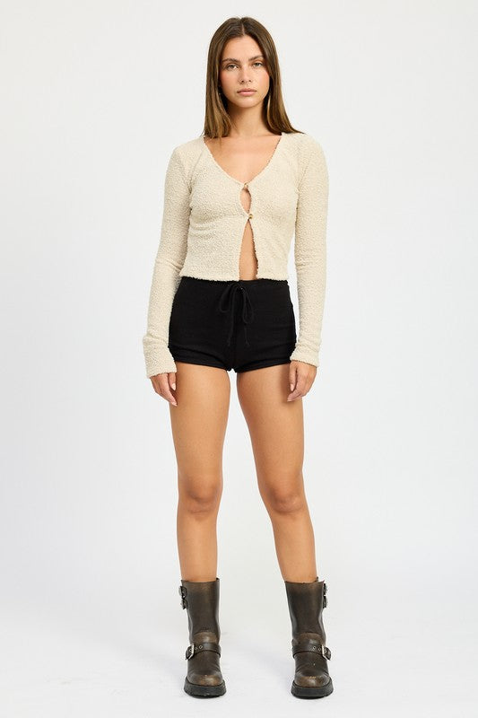 Seashell cropped cardigan with long sleeves and center button closure, open V