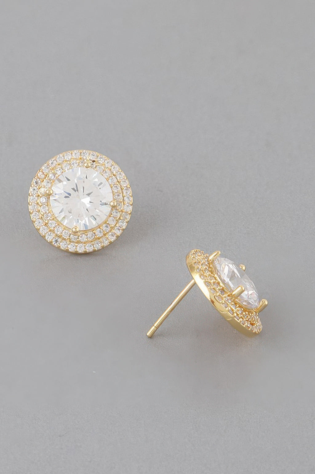 Gold-clear round crystal stud earring, textured halo rim and visible back post