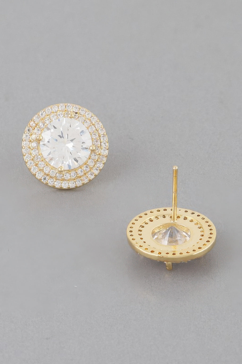Stud earrings showing gold back disc with rhinestone border and clear crystal center