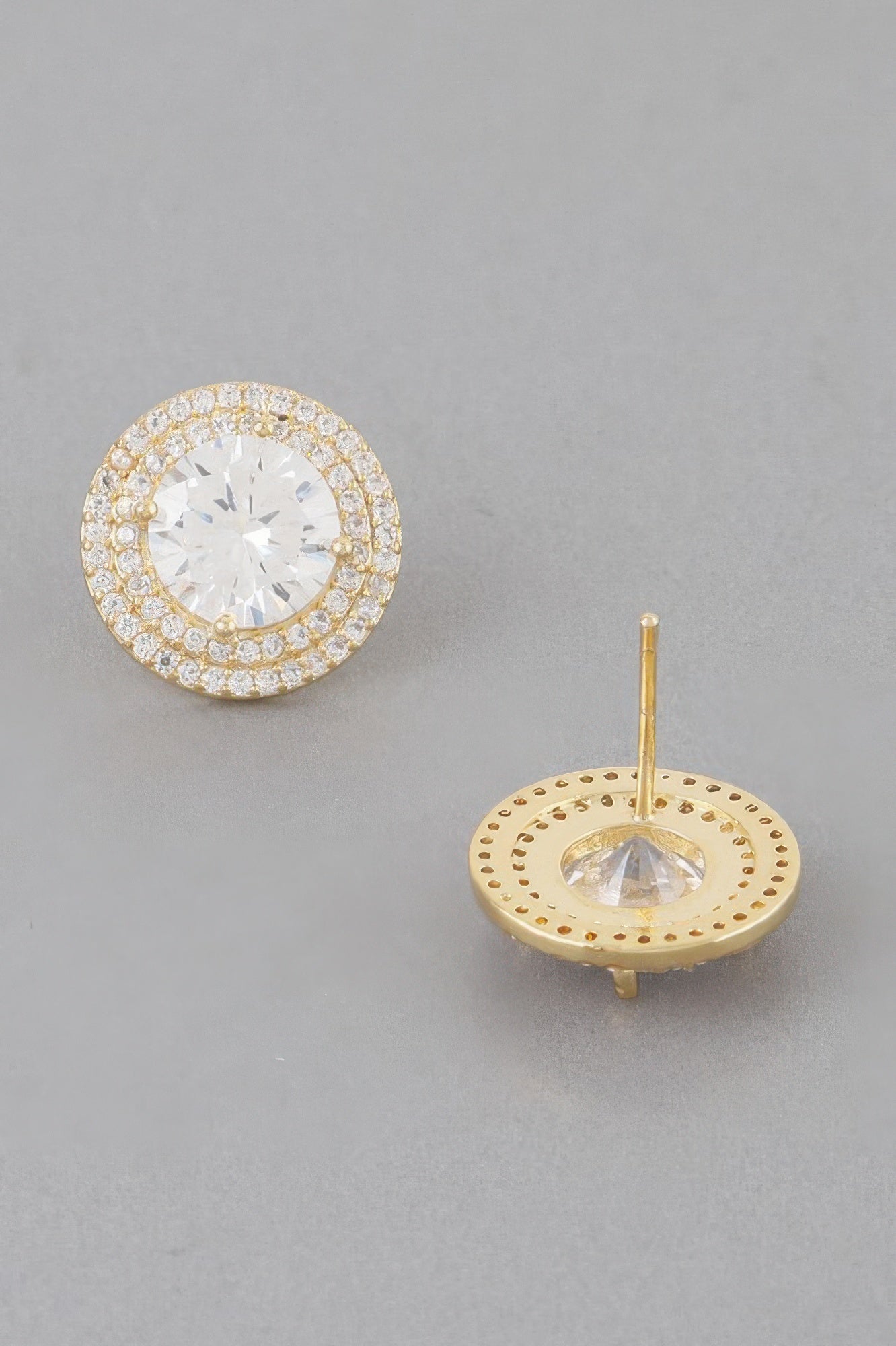 Stud earrings showing gold back disc with rhinestone border and clear crystal center