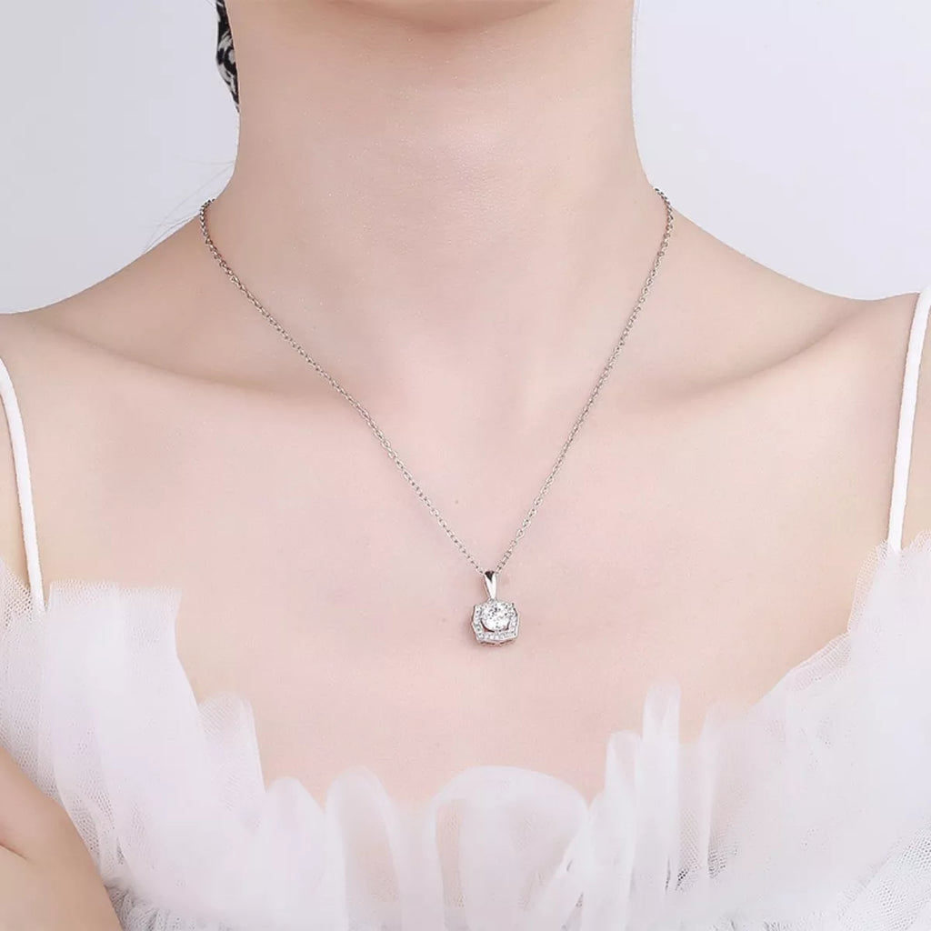 Silver moissanite-style pendant necklace worn at the collar with square halo detail
