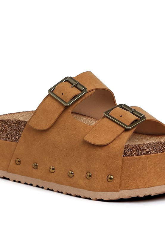 Tan faux leather flatform sandals, close-up of buckle straps and stud detail