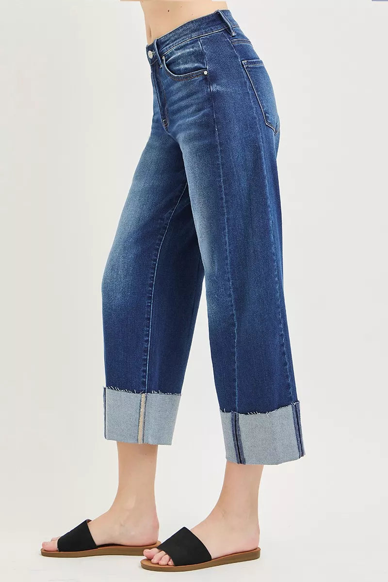 Side view dark blue barrel cuff crop jeans showing roomy straight-leg fit