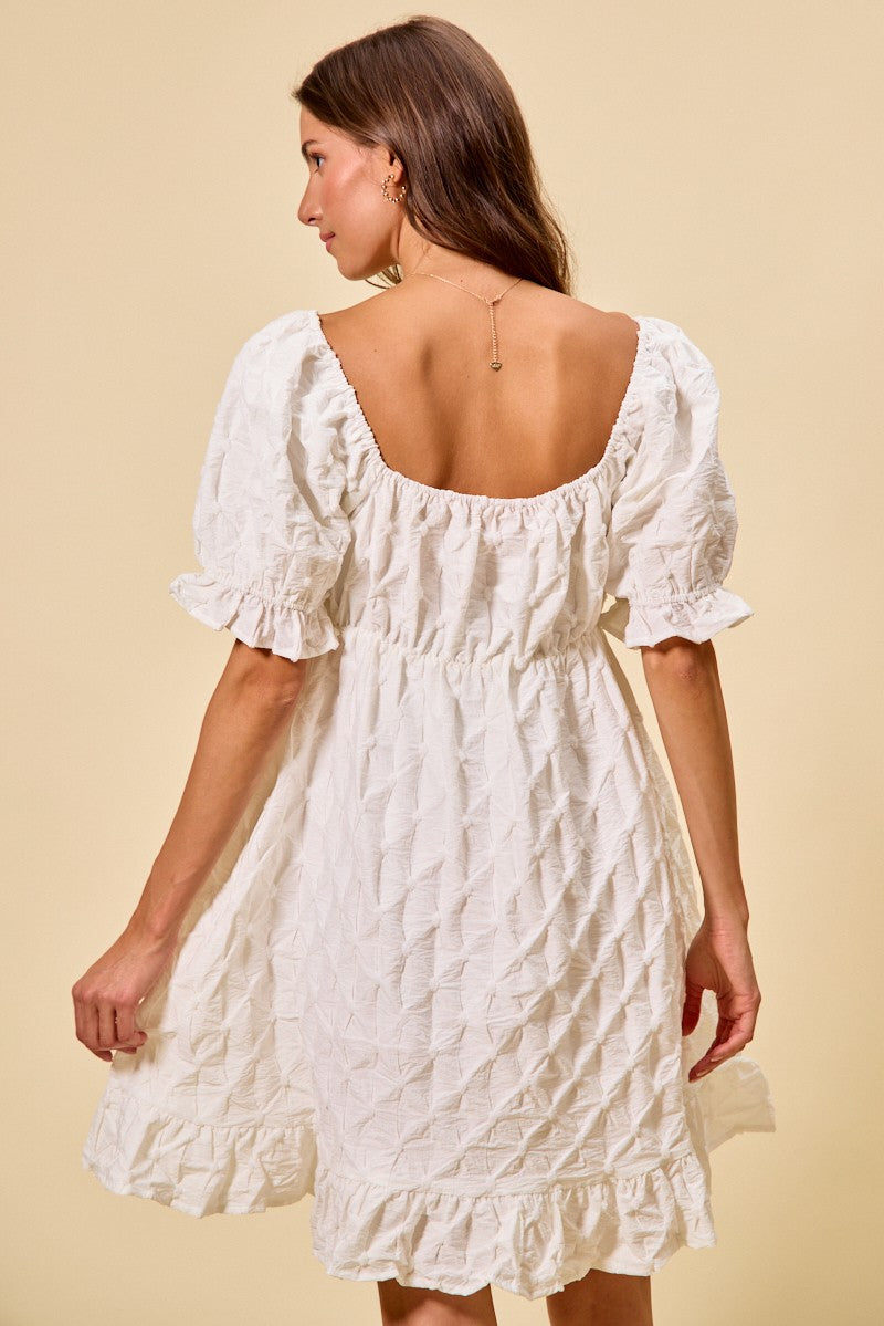 Off-white mini dress back view, square neckline, gathered yoke, textured woven fabric