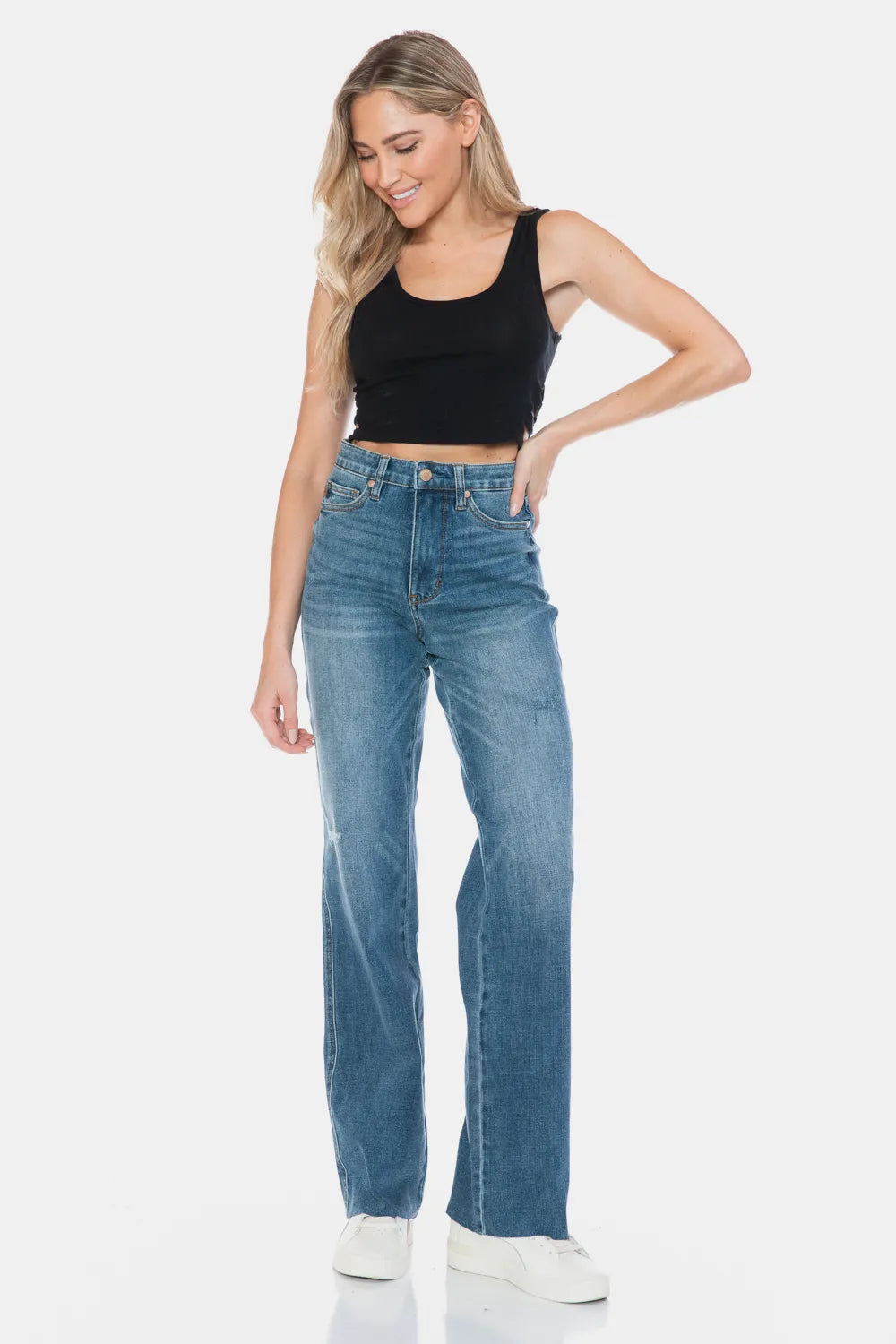 Medium wash straight-leg jeans, five-pocket styling, button-and-zip waistband, raw cuffs