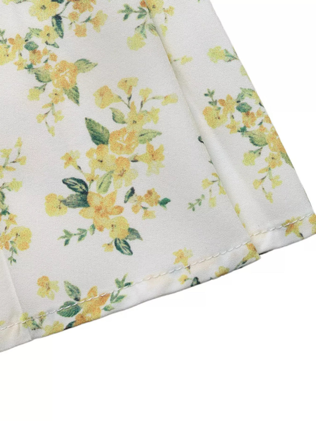Bottom hem of yellow floral mini dress with soft ruffle finish