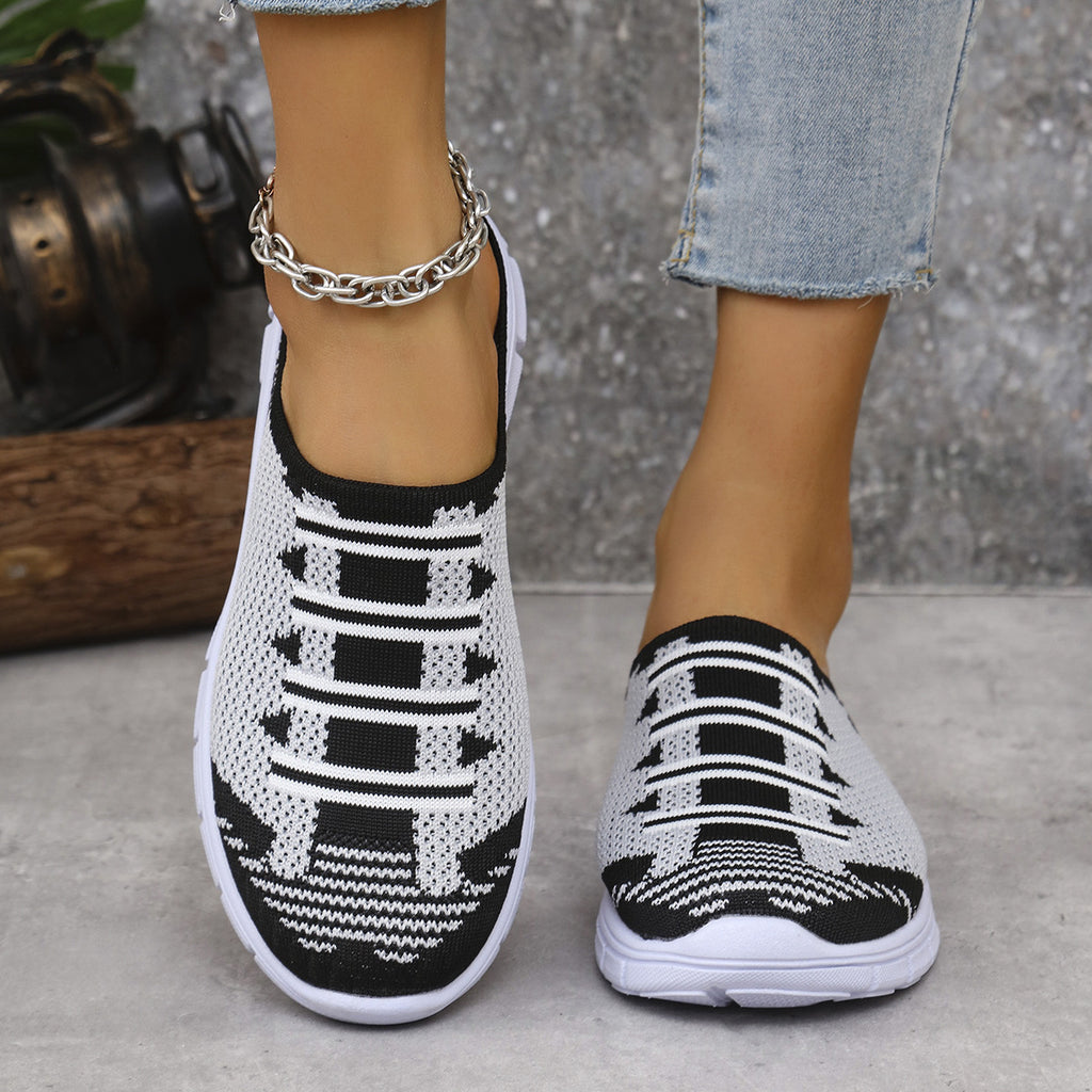 Black knit slip-on sneakers with geometric stripe pattern and white cushioned sole