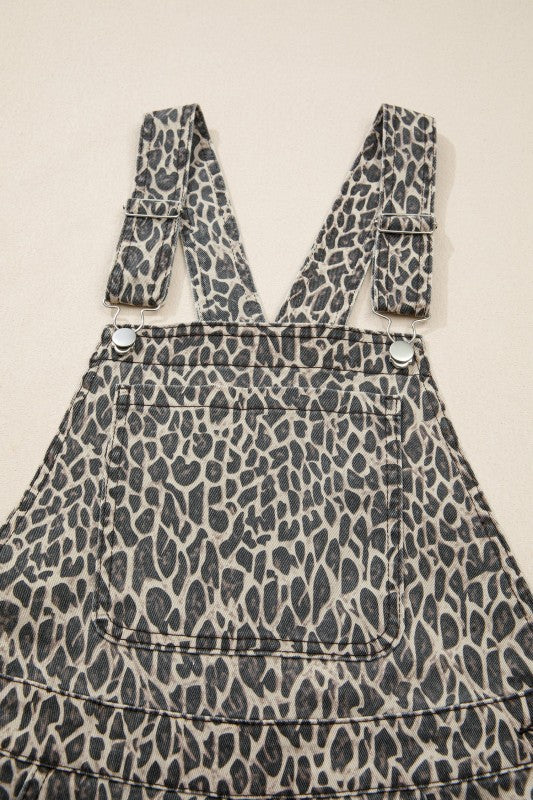 Leopard denim overall front with bib, metal buttons, and stitched panel detail