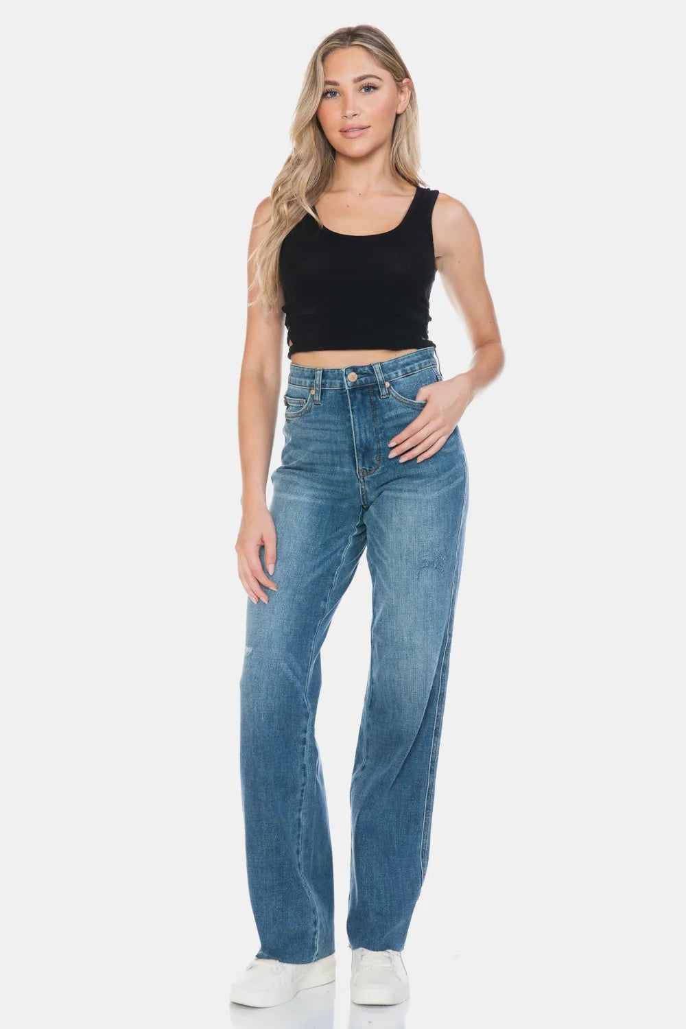 Medium-wash straight jeans with raw hem and front pockets, full-length view