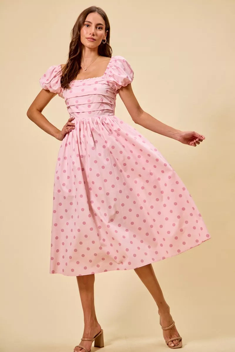 Pink polka-dot midi dress with square neckline, puff sleeves, and pleated gathered skirt
