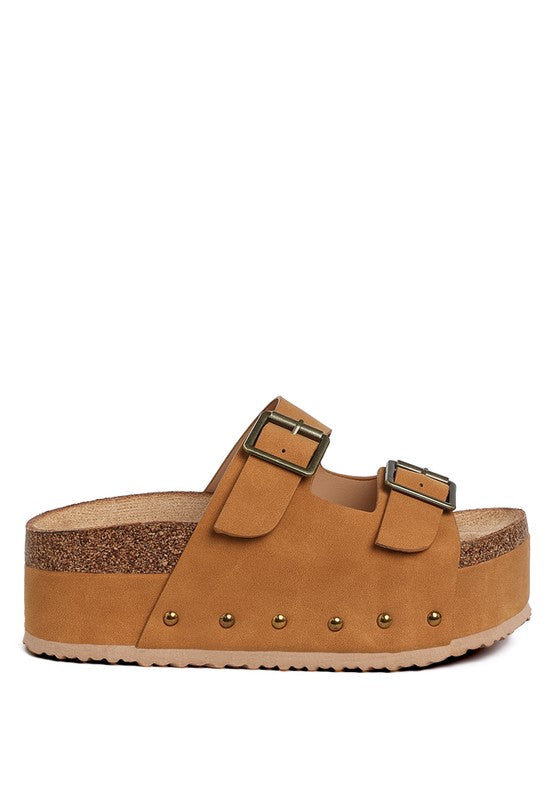 Tan flatform slide sandals with two adjustable buckle straps and stud row