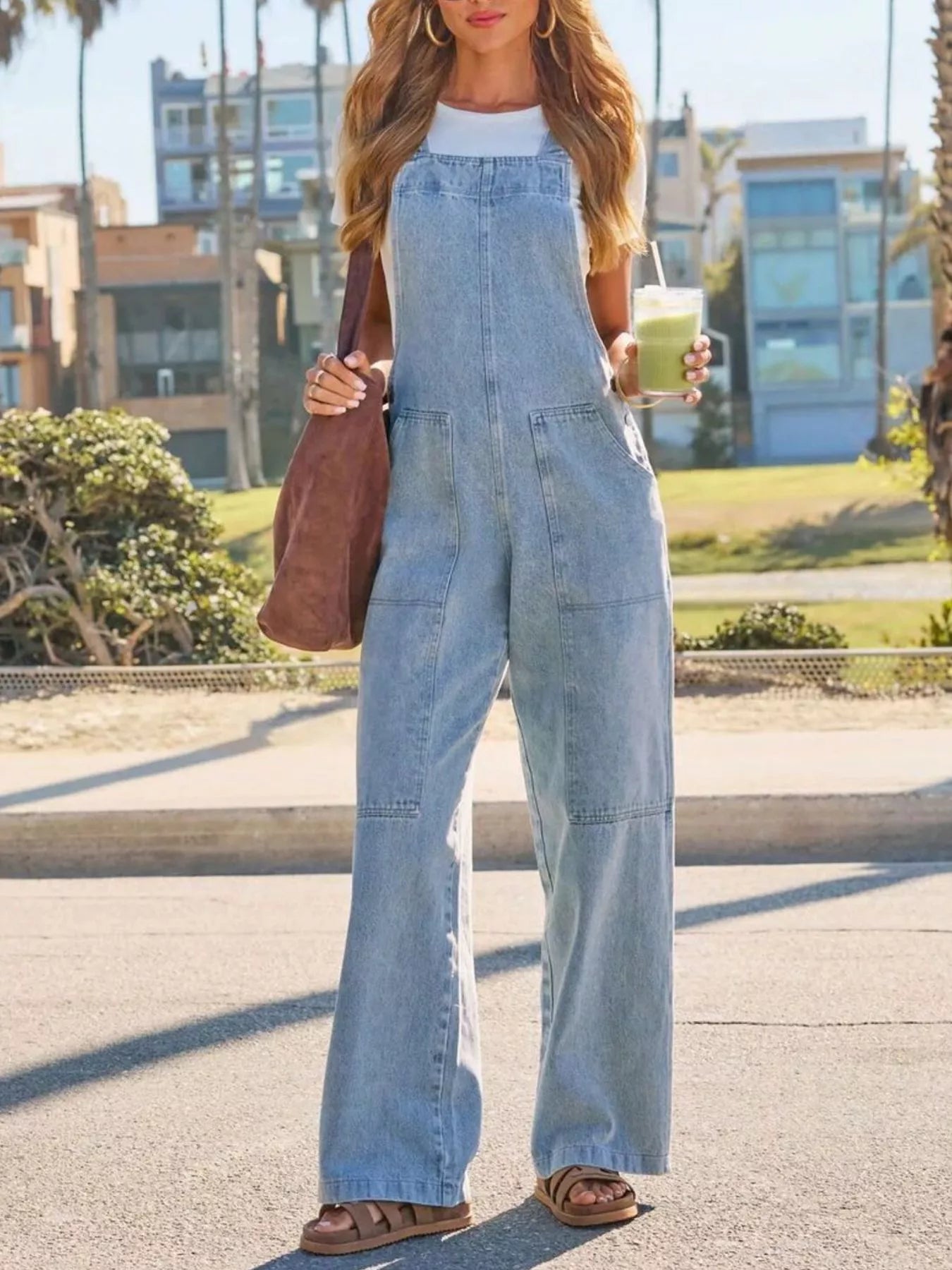 Light blue denim wide-leg overalls with bib front and adjustable straps, front pockets