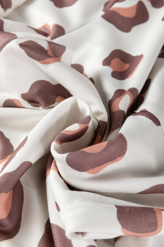 Leopard-print fabric with soft folds on white base
