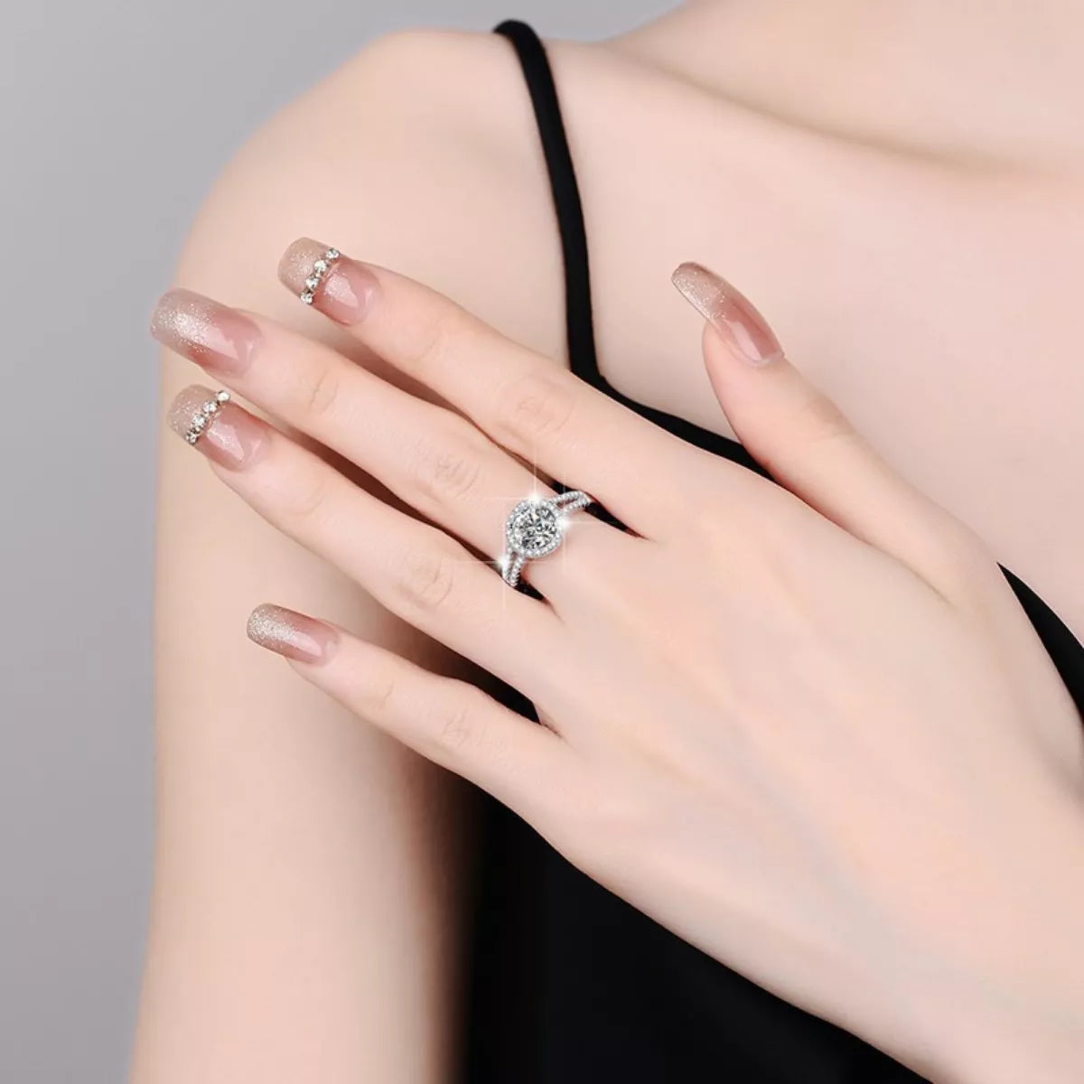 925 silver moissanite ring on hand with round halo center and glittering pavé band