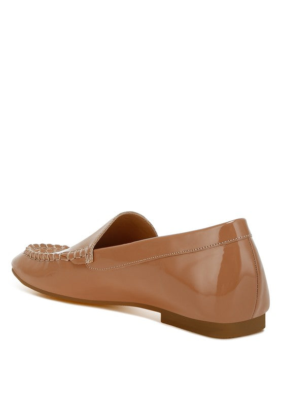 Beige patent pleather loafer side view, woven-stitch trim along vamp