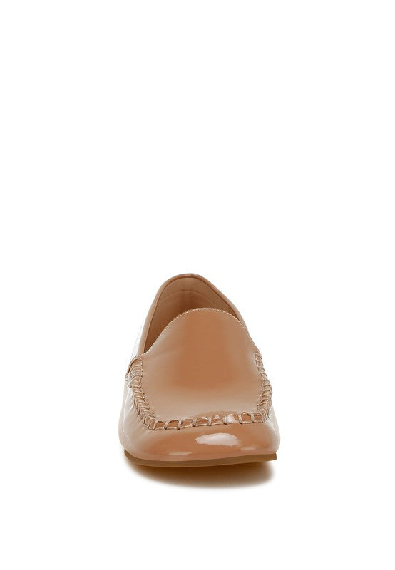 Beige patent pleather loafer back view, stitched seam at heel