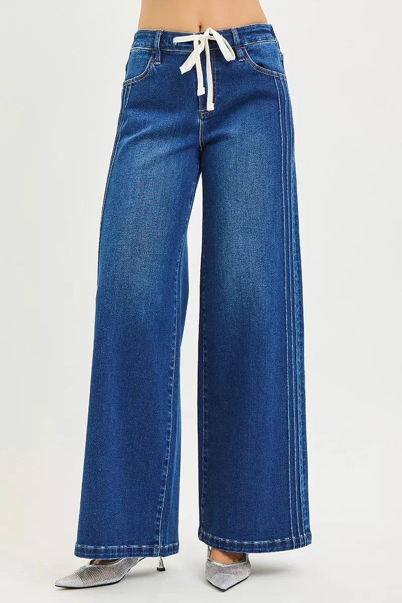 Blue mid-rise wide-leg jeans with white drawstring tie and stitched hems