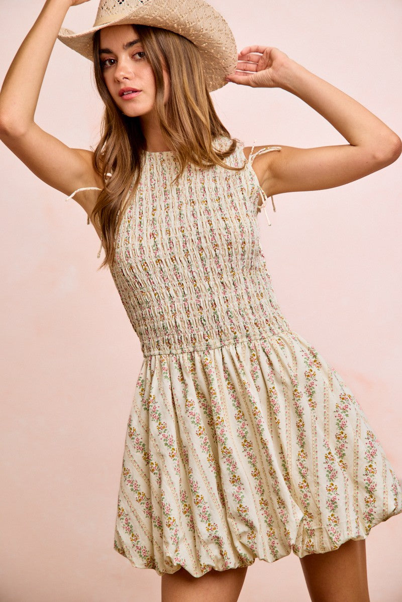 Ivory floral smocked dress with tie-back puff sleeves and tiered, gathered skirt