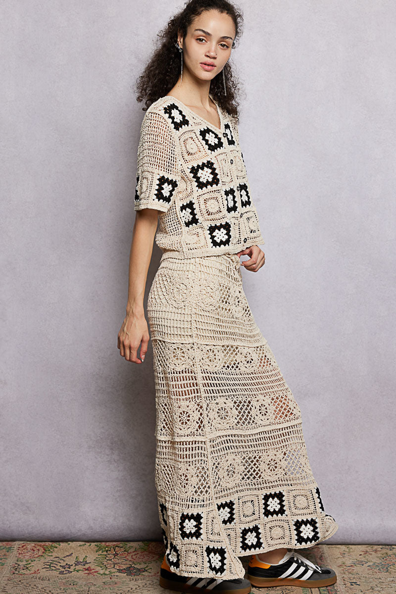 Natural crochet maxi skirt in granny square blocks with black accents along the lower edge