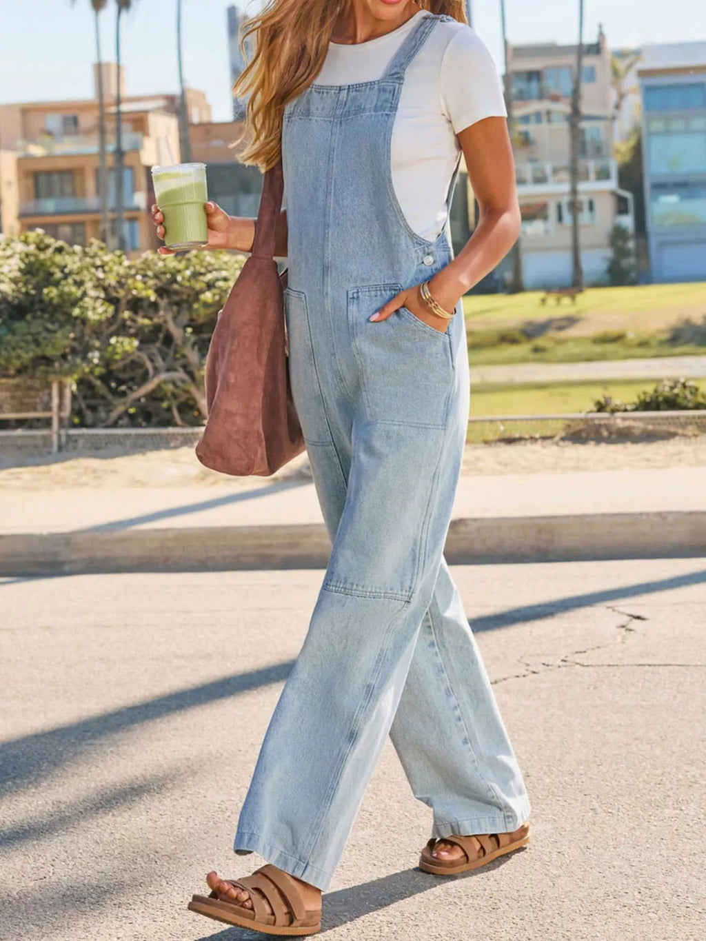 Light blue denim wide-leg overalls with front pocket and roomy flared leg opening