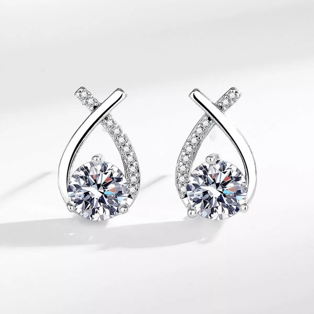Sterling silver moissanite teardrop earrings with pavé accents and round center stone