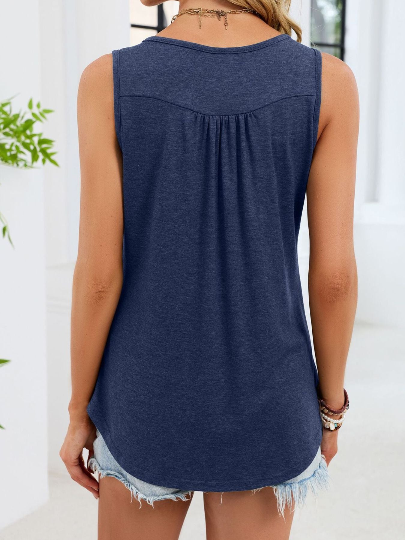 Blue sleeveless tank (back view), round yoke with relaxed fit